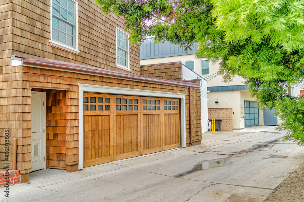 House exterior in Long Beach California with attached garage and wall shingles