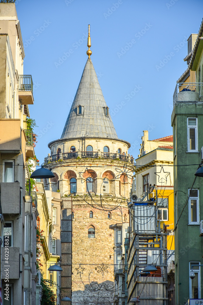 Naklejka premium Famous historical and tourist place Galata tower in Istanbul, Turkey with blue sky background