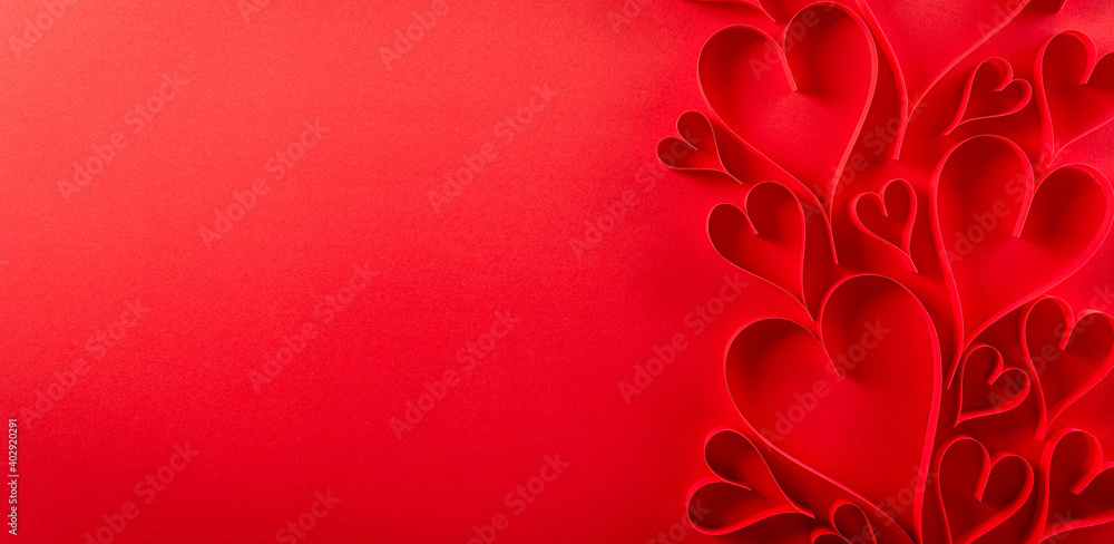 Top view of red paper hearts on red paper background with copy space. Love and Valentine's day concept. Top view of red paper hearts on red paper background with copy space. Love and Valentine's day concept.