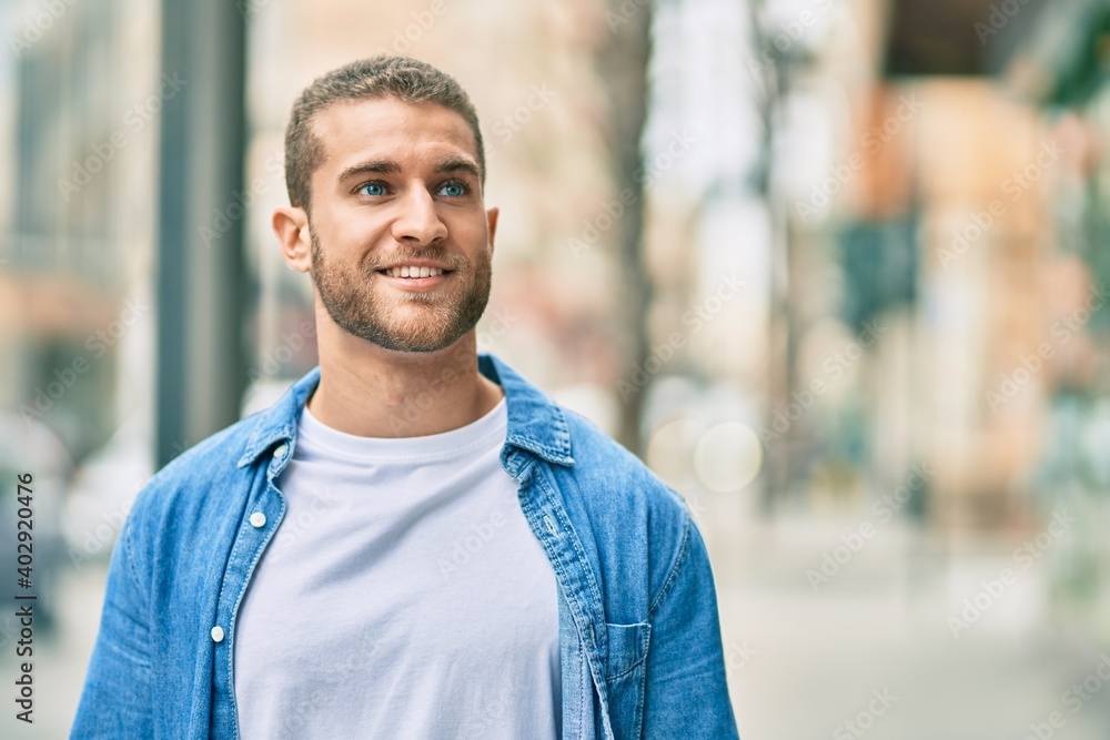 Young caucasian man smiling happy standing at the city. Young caucasian man smiling happy standing at the city.