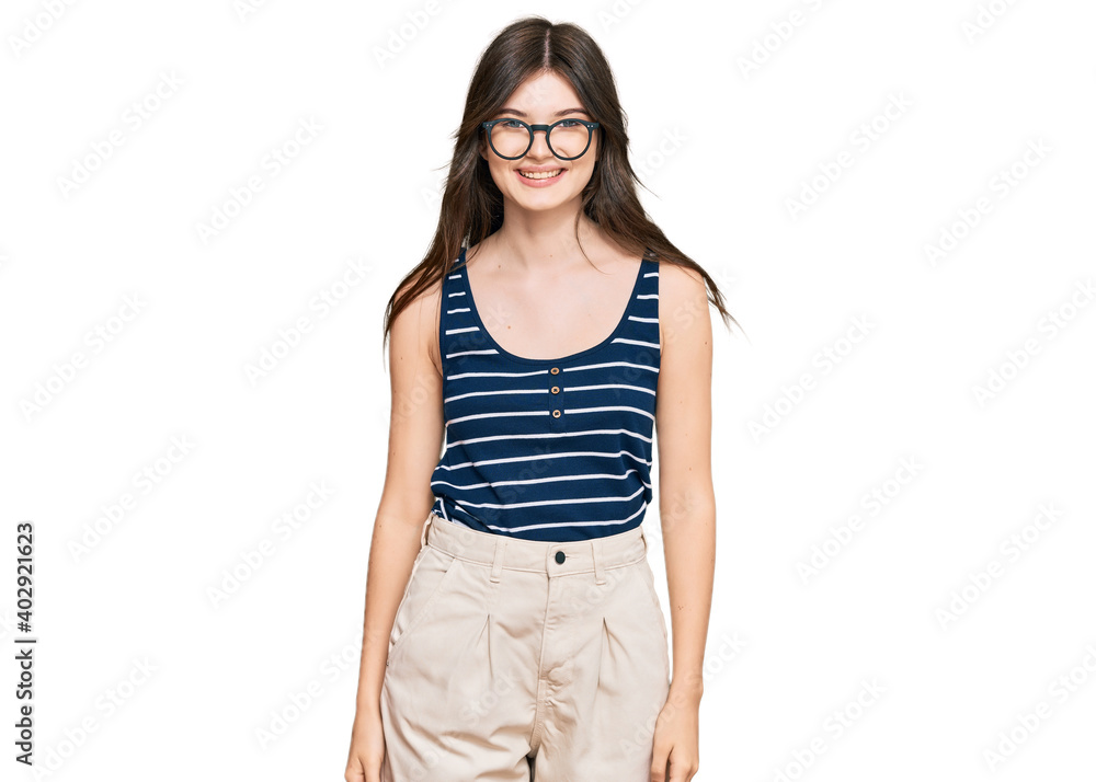 Young beautiful caucasian girl wearing casual clothes and glasses with a happy and cool smile on face. lucky person. Young beautiful caucasian girl wearing casual clothes and glasses with a happy and cool smile on face. lucky person.
