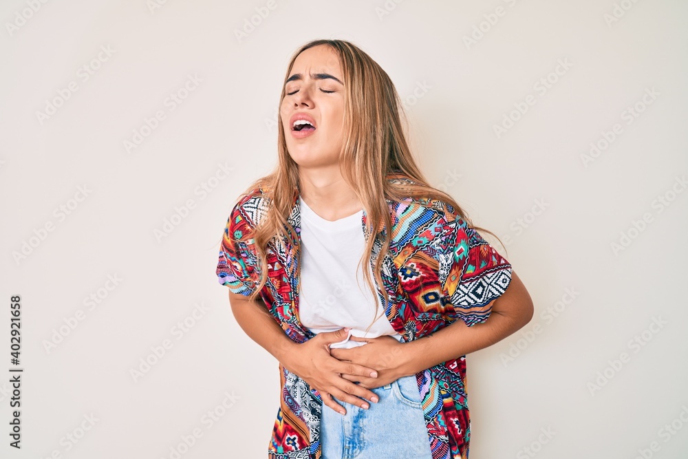 Young beautiful blonde woman wearing modern clothes with hand on stomach because nausea, painful disease feeling unwell. ache concept. Young beautiful blonde woman wearing modern clothes with hand on stomach because nausea, painful disease feeling unwell. ache concept.