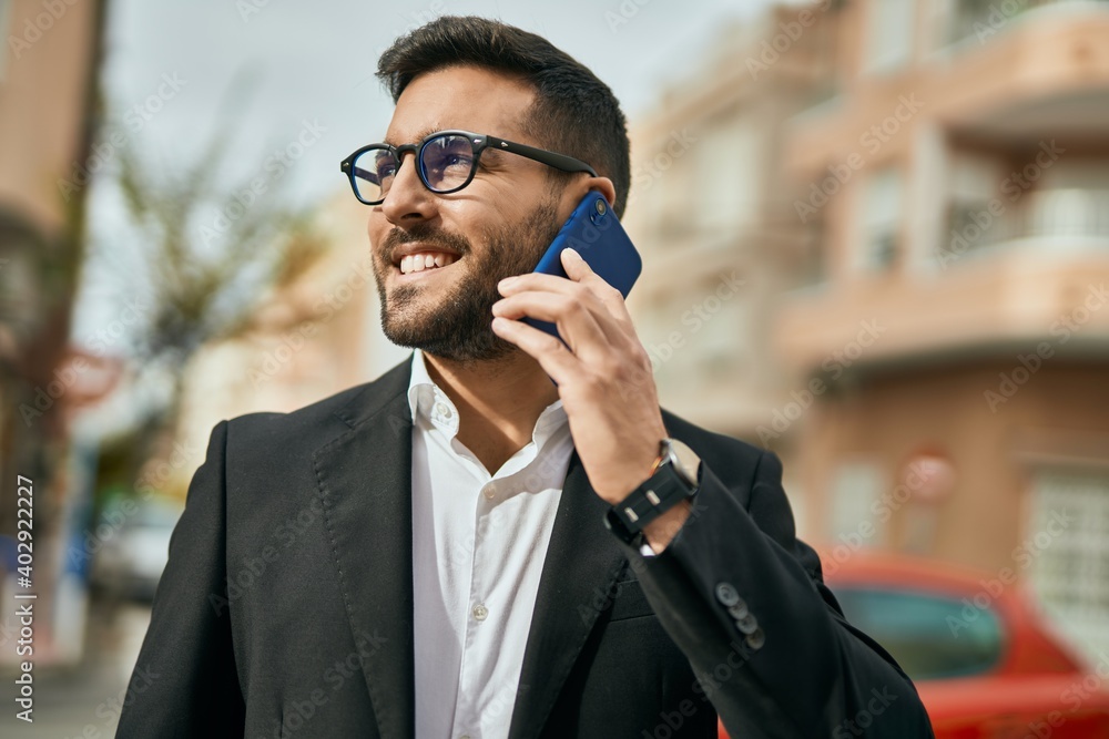 Young hispanic businessman smiling happy talking on the smartphone at the city. Young hispanic businessman smiling happy talking on the smartphone at the city.