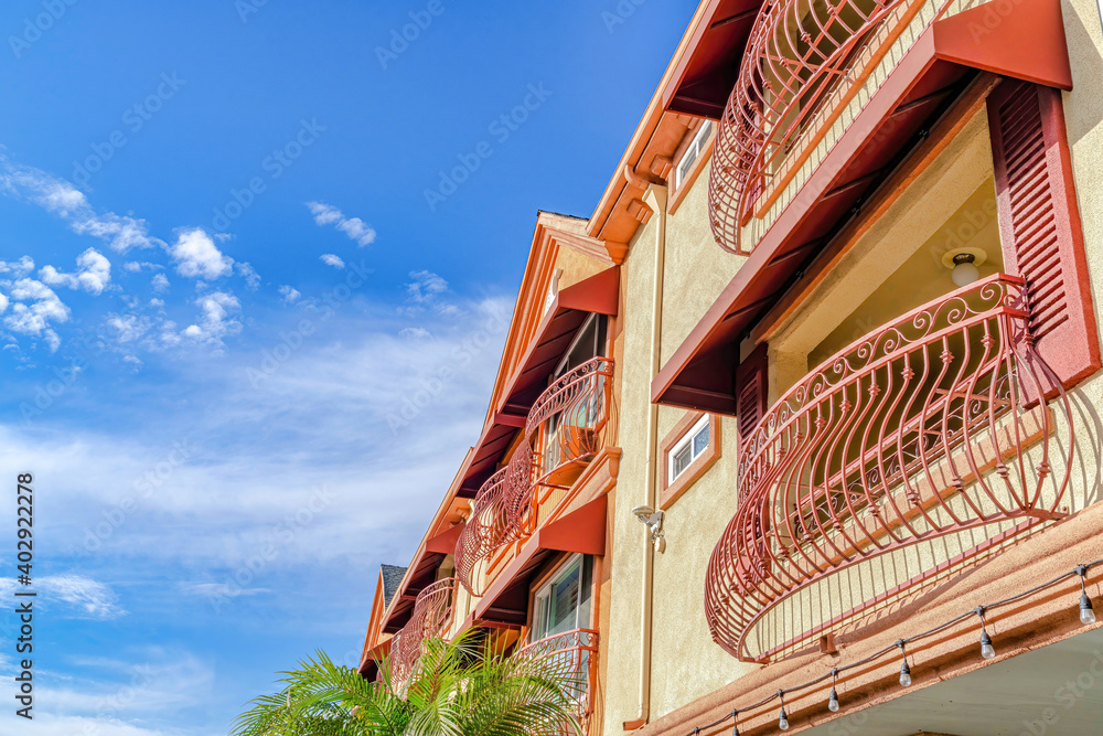 Residential building with curved wrought iron railing on windows and ...
