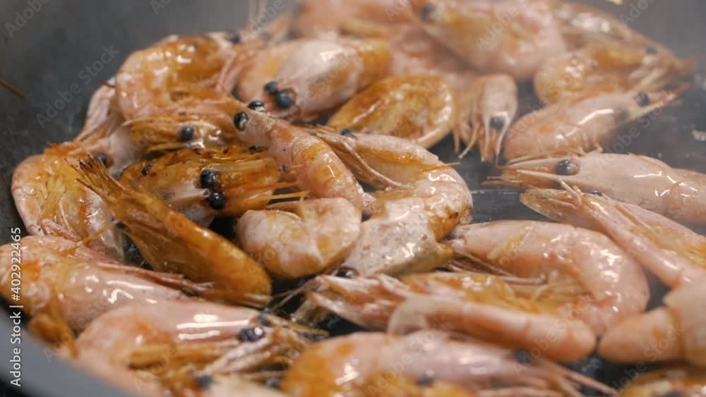 Frying shrimps in a pan with oil and spices slow motion Frying shrimps in a pan with oil and spices slow motion