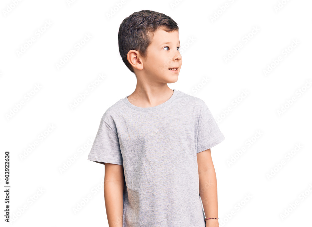 Cute blond kid wearing casual clothes looking away to side with smile on face, natural expression. laughing confident. Cute blond kid wearing casual clothes looking away to side with smile on face, natural expression. laughing confident.