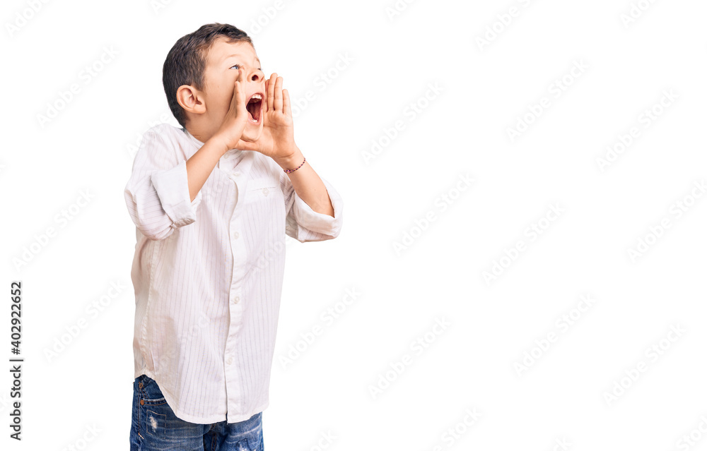 Cute blond kid wearing elegant shirt shouting angry out loud with hands over mouth Cute blond kid wearing elegant shirt shouting angry out loud with hands over mouth