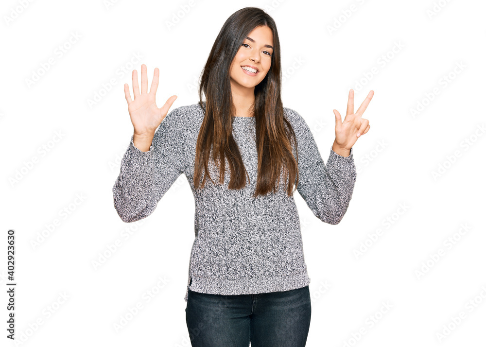Young brunette woman wearing casual winter sweater showing and pointing up with fingers number eight while smiling confident and happy. Young brunette woman wearing casual winter sweater showing and pointing up with fingers number eight while smiling confident and happy.