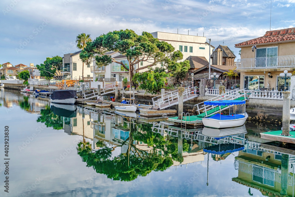 Fototapeta premium Water in Huntington Beach California harbour with reflection of trees and sky