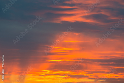 Beautiful sky with yellow, orange and red colors due to sunset. Different types of clouds visible. © Thiago Trevisan