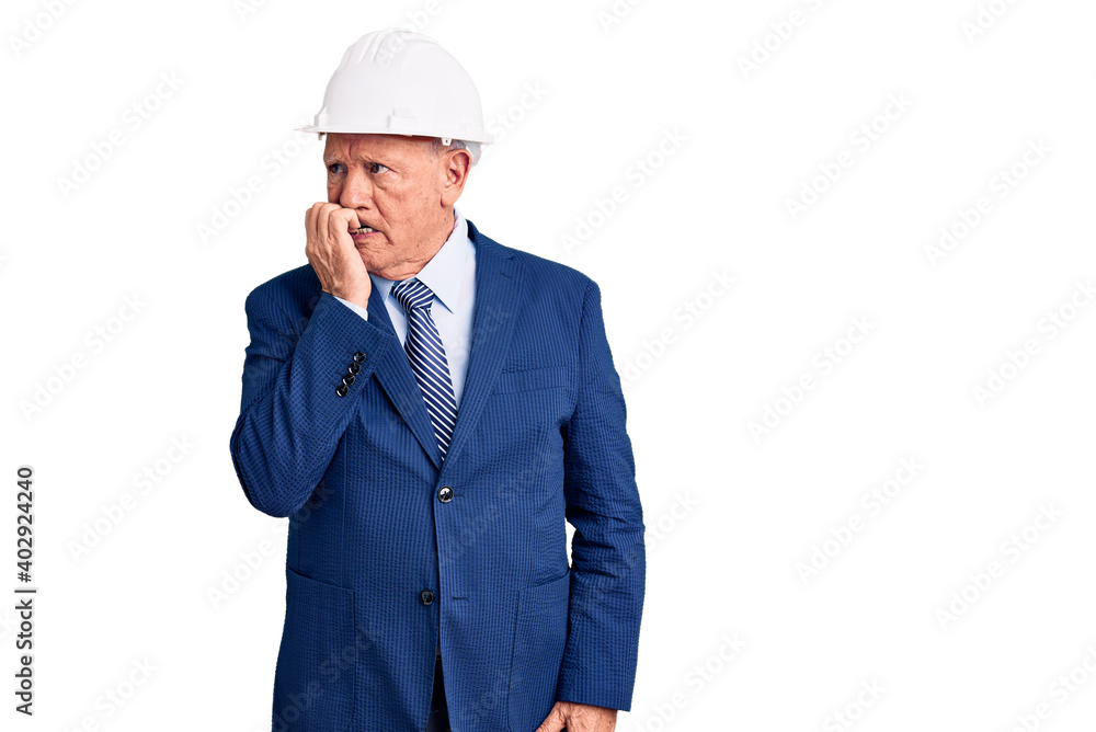 Senior handsome grey-haired man wearing suit and architect hardhat looking stressed and nervous with hands on mouth biting nails. anxiety problem. Senior handsome grey-haired man wearing suit and architect hardhat looking stressed and nervous with hands on mouth biting nails. anxiety problem.