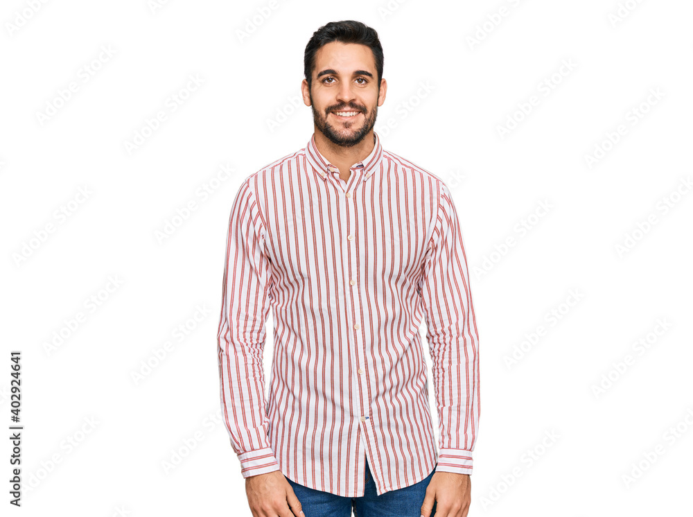 Fototapeta premium Young hispanic man wearing business shirt with a happy and cool smile on face. lucky person.