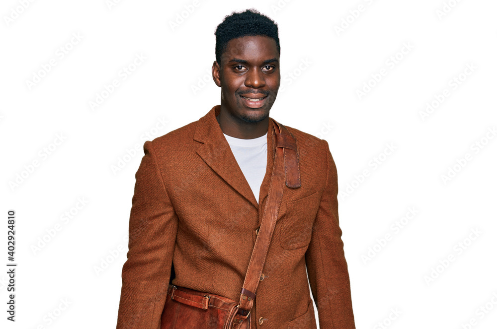 Handsome business black man wearing leather bag looking positive and happy standing and smiling with a confident smile showing teeth Handsome business black man wearing leather bag looking positive and happy standing and smiling with a confident smile showing teeth