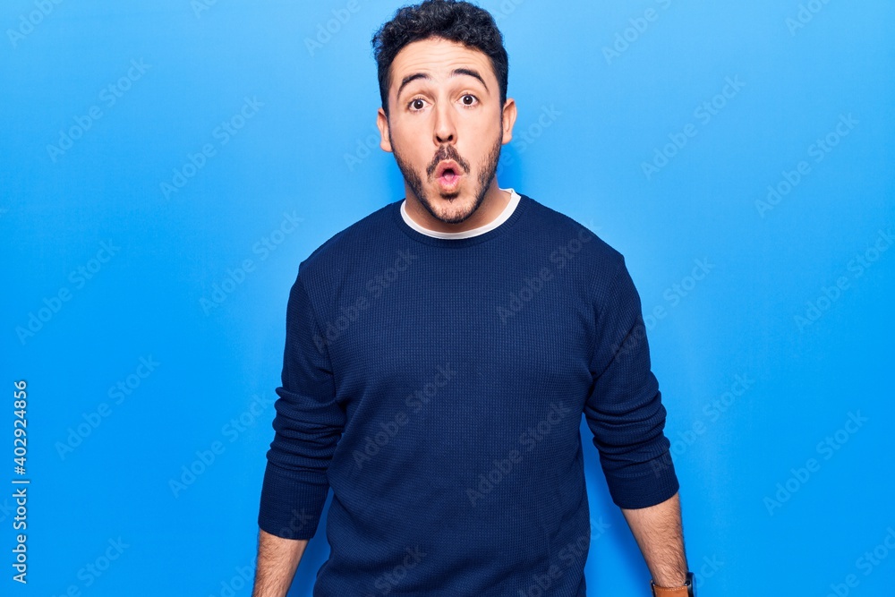 Young hispanic man wearing casual clothes scared and amazed with open mouth for surprise, disbelief face Young hispanic man wearing casual clothes scared and amazed with open mouth for surprise, disbelief face