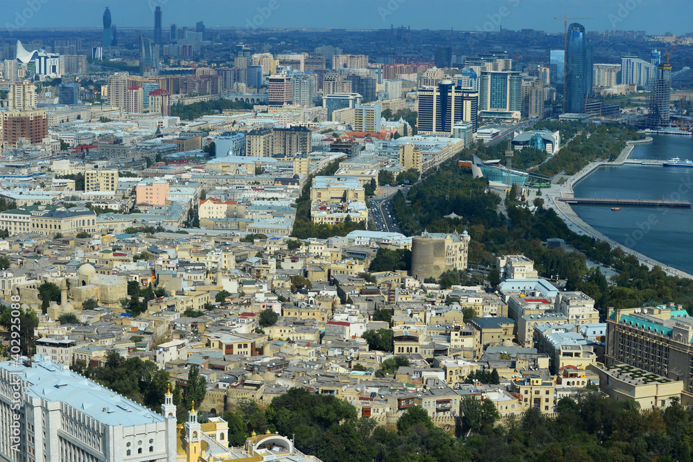Aerial view of Baku, Azerbaijan in the Caucasus Region. Mix of old walled city downtown and modern skyscraper buildings. Baku Boulevard promenade.