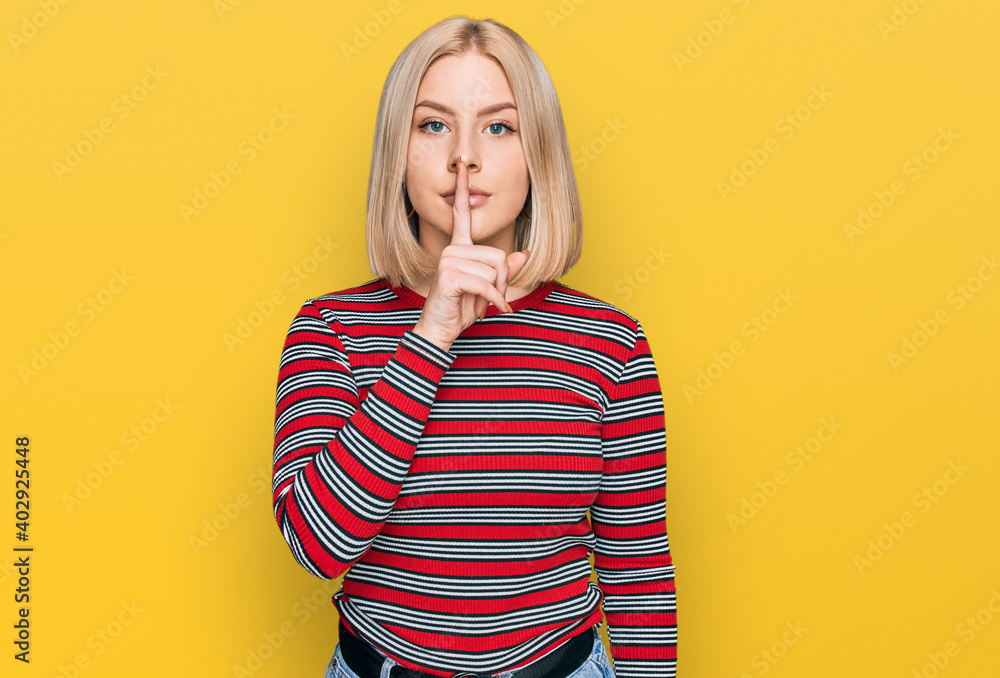 Young blonde woman wearing casual clothes asking to be quiet with finger on lips. silence and secret concept. Young blonde woman wearing casual clothes asking to be quiet with finger on lips. silence and secret concept.