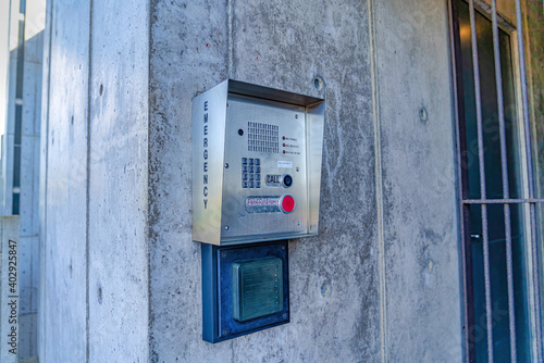 Emergency security box with call button mounted on the wall of campus building