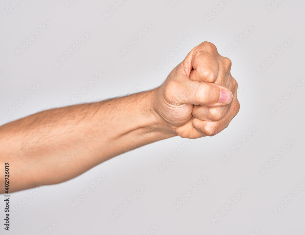 Hand of caucasian young man showing fingers over isolated white background doing protest and revolution gesture, fist expressing force and power