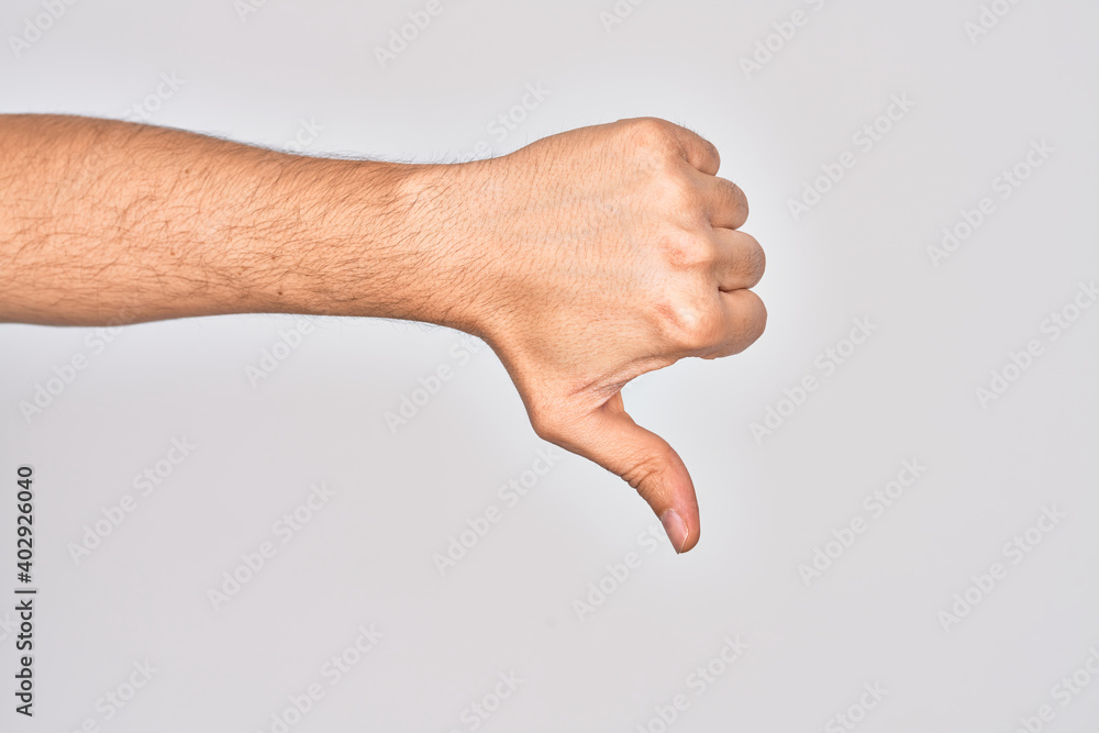 Hand of caucasian young man showing fingers over isolated white background doing thumbs down rejection gesture, disapproval dislike and negative sign Hand of caucasian young man showing fingers over isolated white background doing thumbs down rejection gesture, disapproval dislike and negative sign