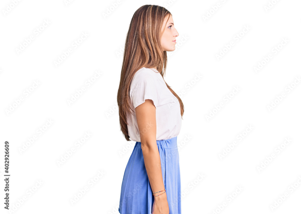 Young beautiful blonde woman wearing summer style looking to side, relax profile pose with natural face with confident smile. Young beautiful blonde woman wearing summer style looking to side, relax profile pose with natural face with confident smile.