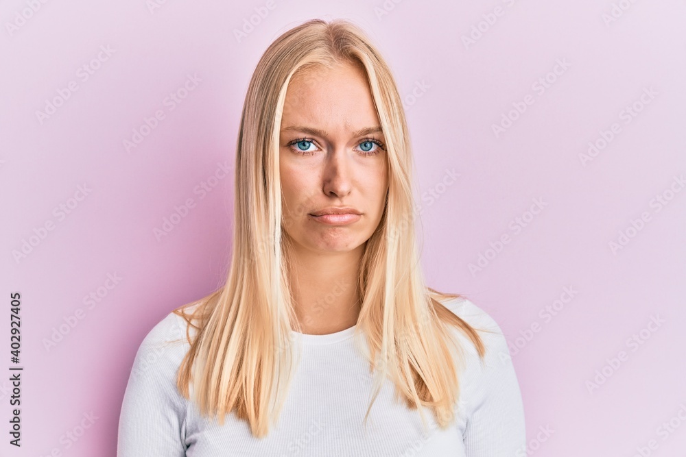 Fototapeta premium Young blonde girl wearing casual clothes depressed and worry for distress, crying angry and afraid. sad expression.