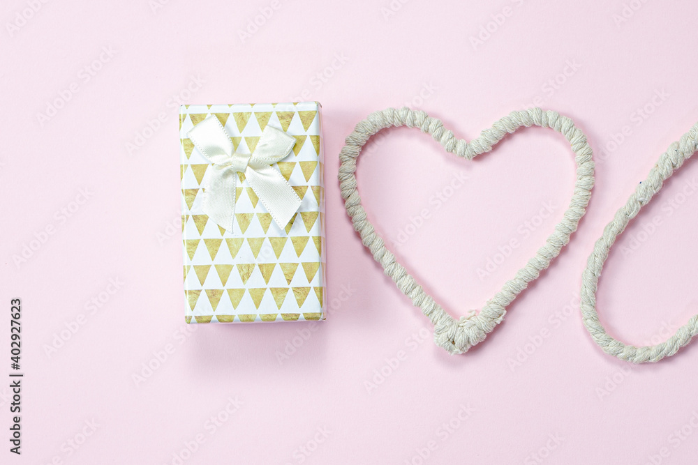 Rope heart, gift on pink background