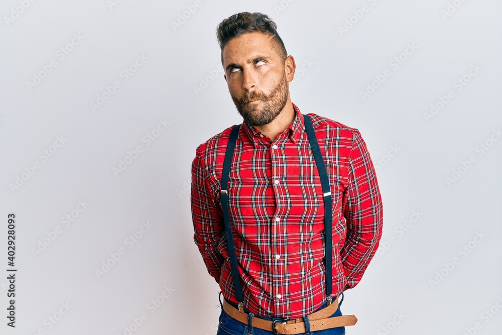 Handsome man with beard wearing hipster elegant look making fish face with lips, crazy and comical gesture. funny expression. Handsome man with beard wearing hipster elegant look making fish face with lips, crazy and comical gesture. funny expression.