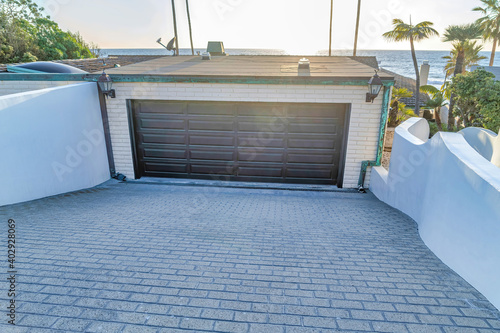 Garage of house against blue ocean and bright sunny sky in San Diego California