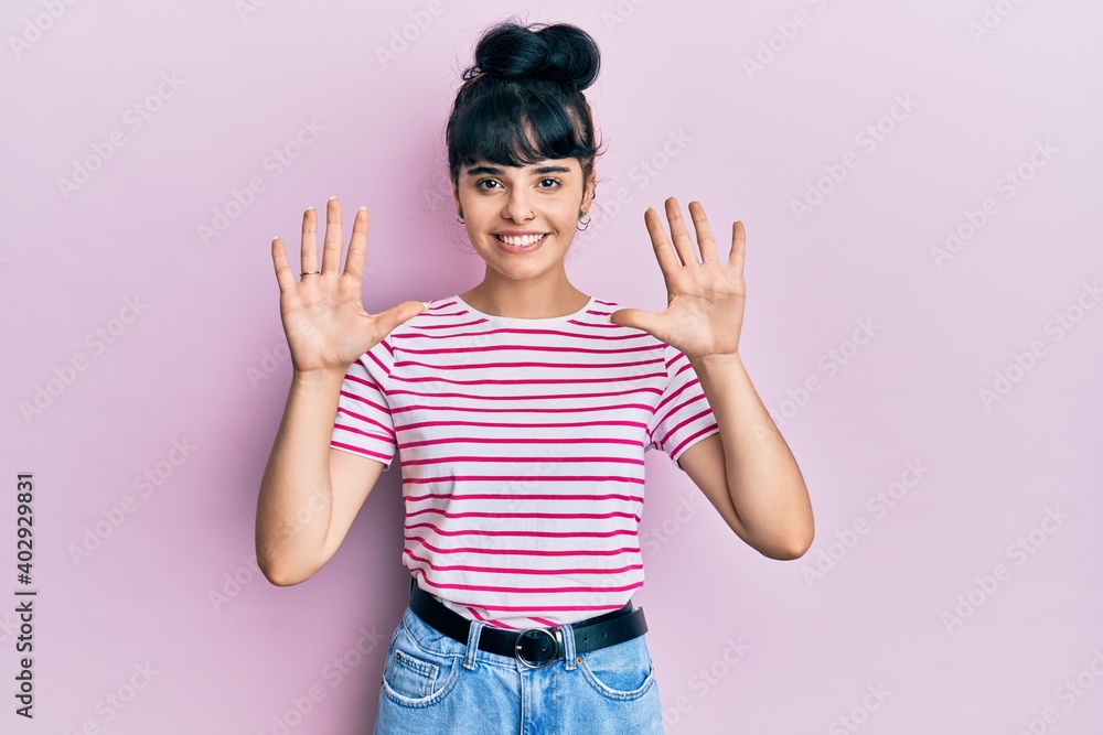 Young hispanic girl wearing casual clothes showing and pointing up with fingers number ten while smiling confident and happy. Young hispanic girl wearing casual clothes showing and pointing up with fingers number ten while smiling confident and happy.