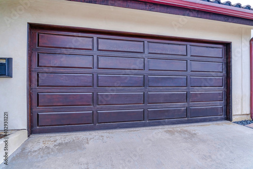 Brown wood panel door of attached garage in San Diego California neighborhood