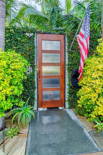 Gate door with frosted glass pane and American flag in San Diego California home photo
