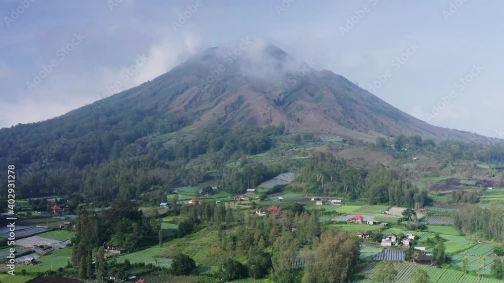 Aerial view of the active volcano Mount Batur in the province of Kintamani in Bali Indonesia with local villages surrounding the peak. Aerial view of the active volcano Mount Batur in the province of Kintamani in Bali Indonesia with local villages surrounding the peak.