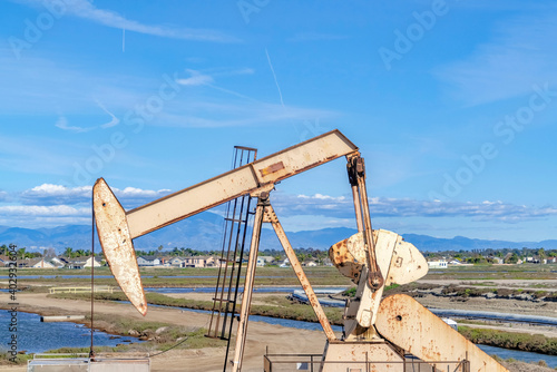Oil rig against wetlands and sky at Bolsa Chica Ecological Reserve California