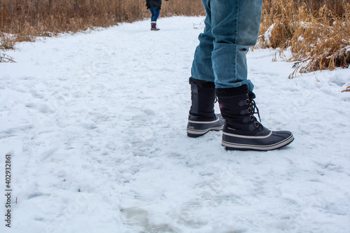 Wallpaper Mural Winter boots standing on snow while hiking on a path in the woods. Torontodigital.ca
