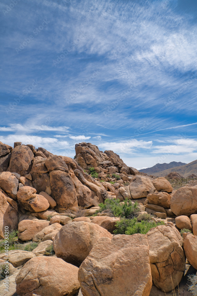 Huge rugged rocks in the dry desert of Joshua Tree National Park in California