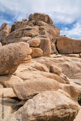 Huge sunlit rocks forming mountain in the scenic Joshua Tree National Park