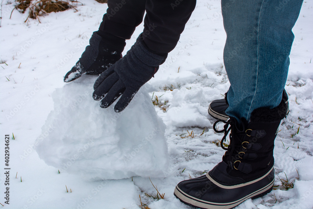 custom made wallpaper toronto digitalGlove covered hands building snowballs and snowmen in the deep snow.