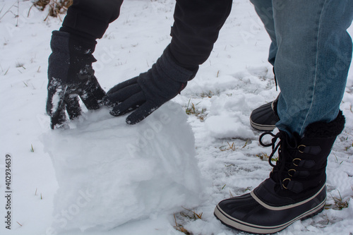 Wallpaper Mural Glove covered hands building snowballs and snowmen in the deep snow. Torontodigital.ca