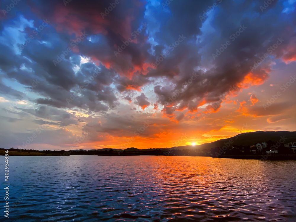 mountain lake landscape in cloudy sky at sunset