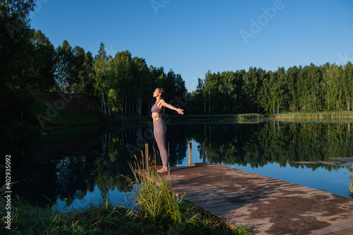 Calm young woman taking deep breath of fresh air relaxing meditating enjoying peace, serene tranquil girl doing yoga exercise feel no stress free relief © romankosolapov
