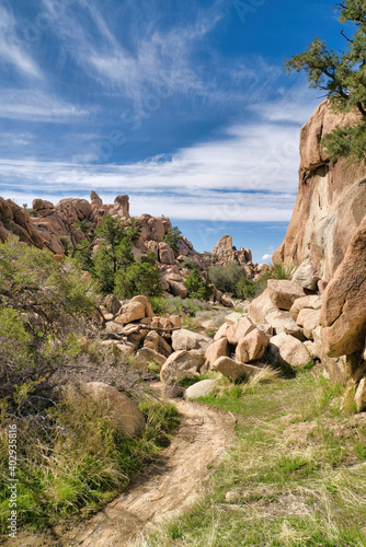 Hiking dirt road amidst giant rocks at Joshua Tree National Park California