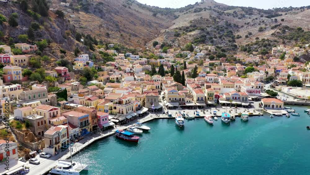 Aerial view of the beautiful greek island of Symi (Simi) with colourful houses and small boats. Greece, Symi island, view of the town of Symi (near Rhodes), Dodecanese. Aerial view of the beautiful greek island of Symi (Simi) with colourful houses and small boats. Greece, Symi island, view of the town of Symi (near Rhodes), Dodecanese.