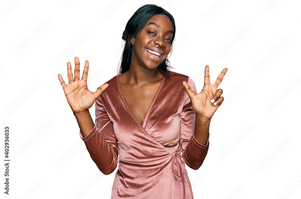 Young african american woman wearing sexy party dress showing and pointing up with fingers number eight while smiling confident and happy. Young african american woman wearing sexy party dress showing and pointing up with fingers number eight while smiling confident and happy.