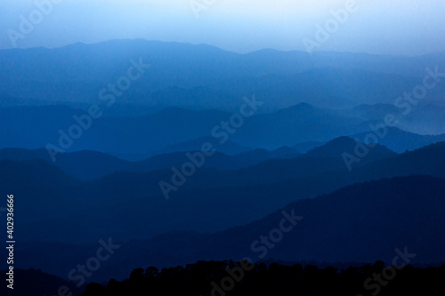 Dark Blue mysterious Mountain Landscape in cloudy sunset sky