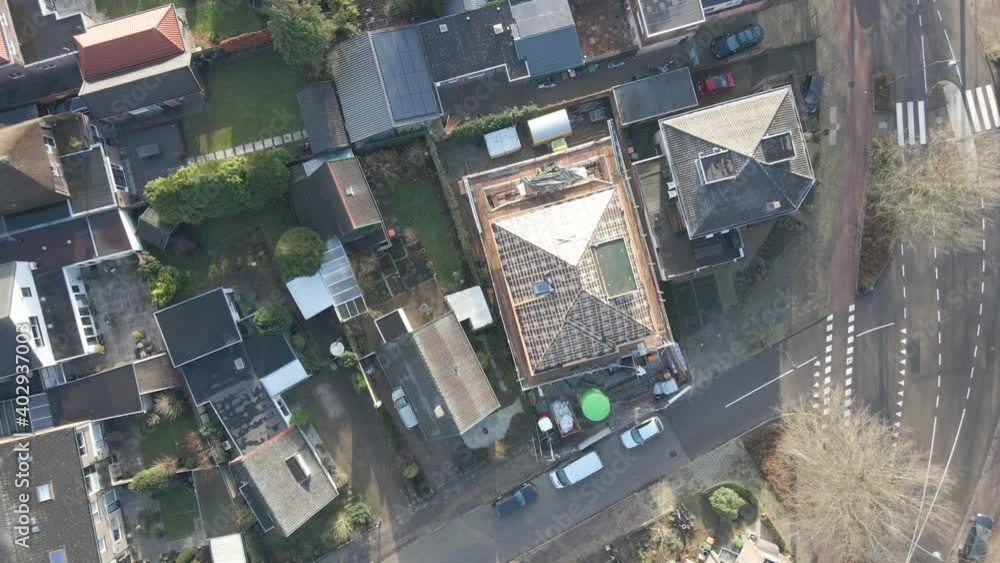 Top down aerial of house rooftop under construction - drone setting down and spinning Top down aerial of house rooftop under construction - drone setting down and spinning