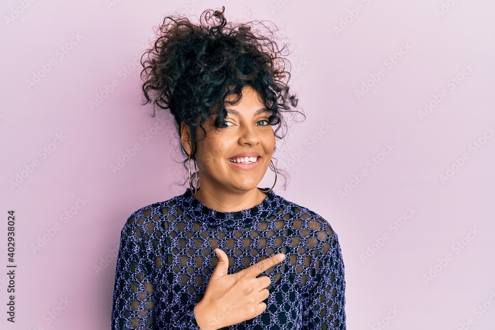 Young hispanic woman wearing casual clothes smiling cheerful pointing with hand and finger up to the side Young hispanic woman wearing casual clothes smiling cheerful pointing with hand and finger up to the side