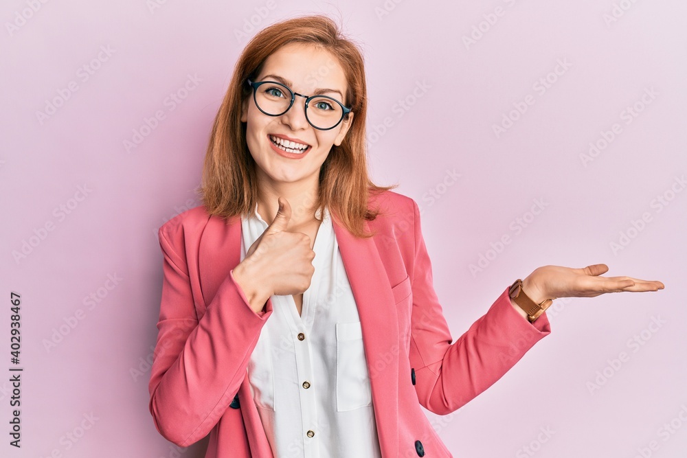 Young caucasian woman wearing business style and glasses showing palm hand and doing ok gesture with thumbs up, smiling happy and cheerful