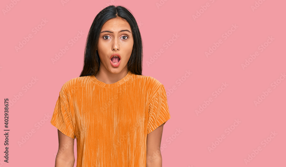 Fototapeta premium Young brunette arab woman wearing casual clothes afraid and shocked with surprise expression, fear and excited face.