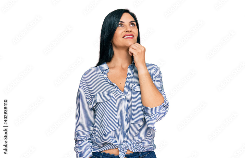Young caucasian woman wearing casual clothes with hand on chin thinking about question, pensive expression. smiling and thoughtful face. doubt concept. Young caucasian woman wearing casual clothes with hand on chin thinking about question, pensive expression. smiling and thoughtful face. doubt concept.