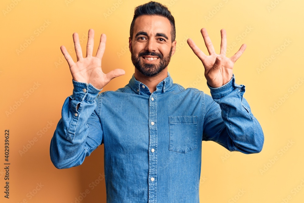 Young hispanic man wearing casual clothes showing and pointing up with fingers number nine while smiling confident and happy. Young hispanic man wearing casual clothes showing and pointing up with fingers number nine while smiling confident and happy.